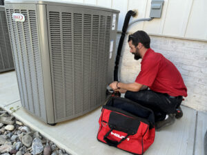 Technicians repairing AC unit