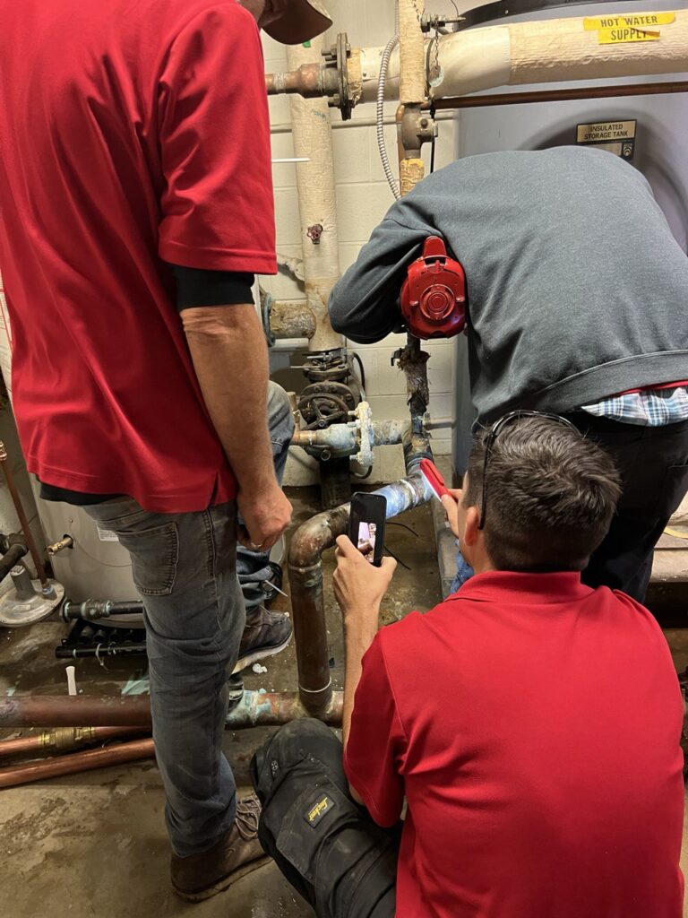 Technician inspecting commercial HVAC system for maintenance